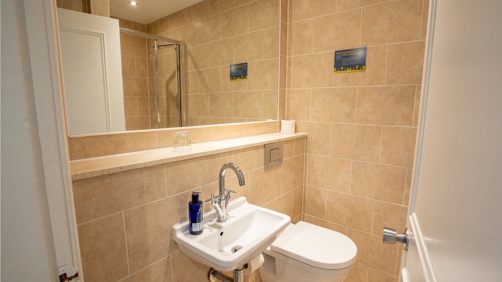 Bathroom with shower, toilet, and sink.