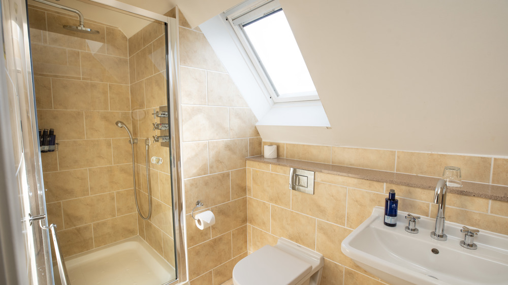 Bathroom with toilet, sink and mirror.