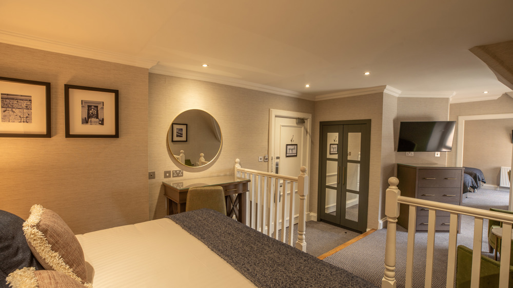 Family apartment with king-sized bed in a semi-gated area. You can see the other sleeping area in the background.