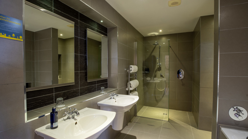 Leigh signature double bathroom with double sinks and a walk-in shower.