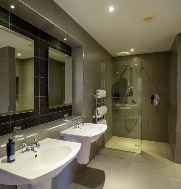 Leigh signature double bathroom with double sinks and a walk-in shower.